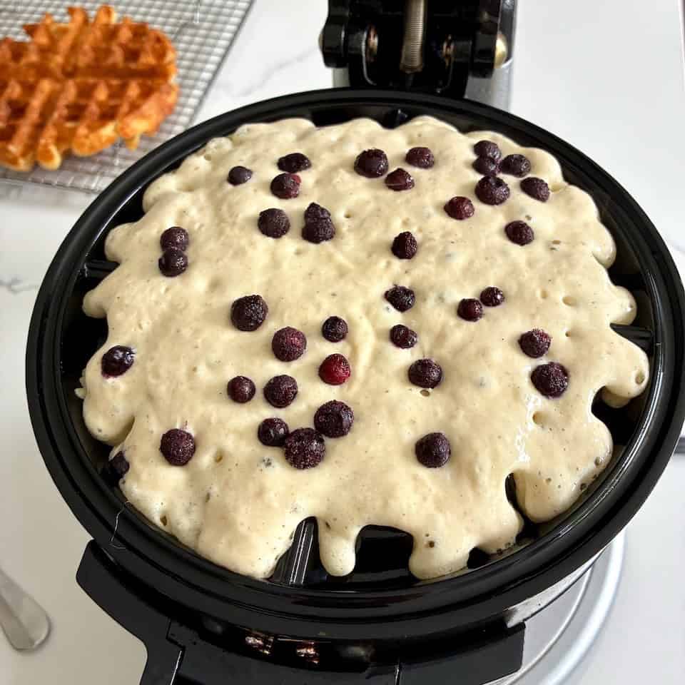Preparing wild blueberry waffles.
