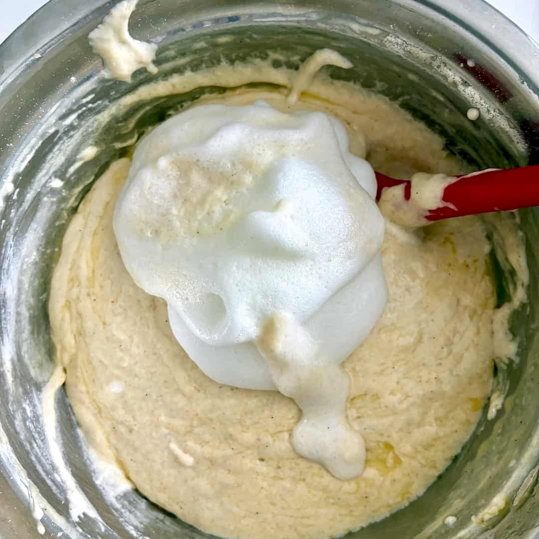 Folding egg whites into waffle batter.