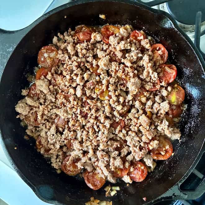 Layering ingredients in a skillet.