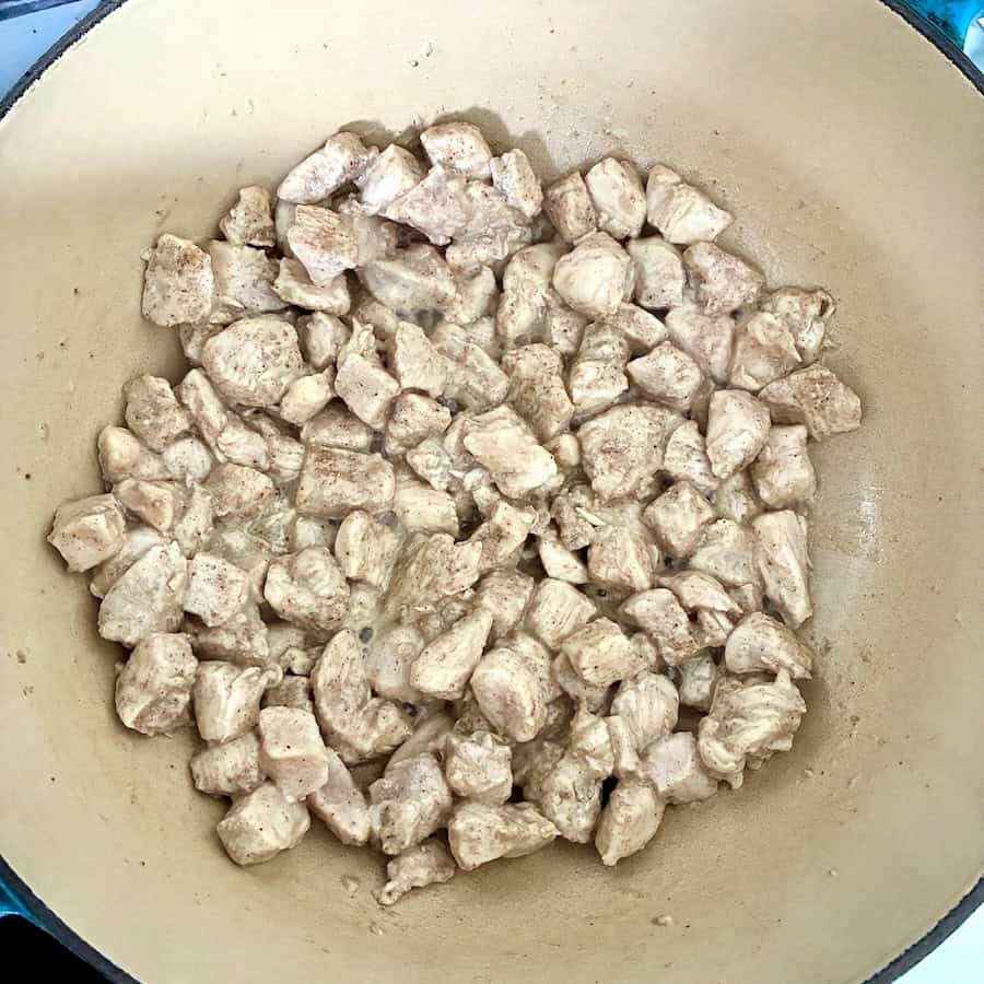 Cooking chicken until no longer pink.