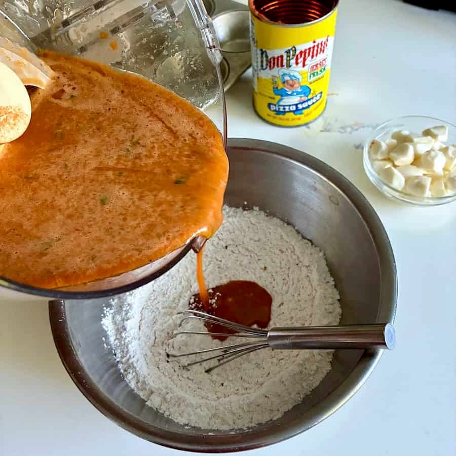 Pouring wet into dry ingredients.