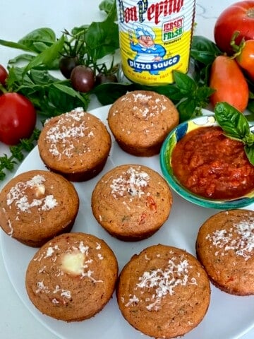 Plate of pizza muffins with sauce.