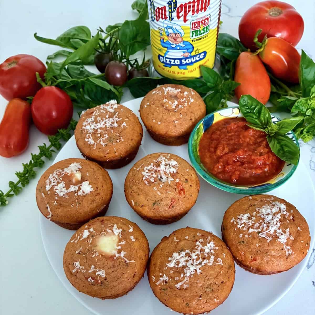 Plate of pizza muffins with sauce.