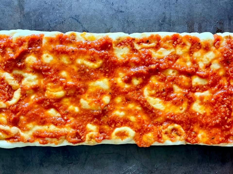 Pizza sauce on flatbread crust.